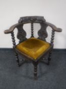 A Victorian heavily carved oak corner chair