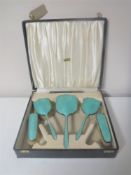 A cased Art Deco five-piece silver and enamel dressing table brush set,