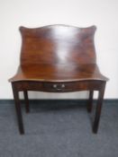 A George III shaped front mahogany foldover top tea table