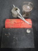 A metal tool box containing hand tools,