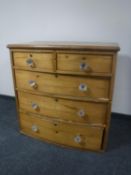 A Victorian pine bow-fronted five drawer chest with glass handles