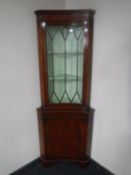 An inlaid mahogany inverted corner cabinet