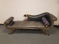 An Empire style studded leather scroll ended chaise with bolster cushion,