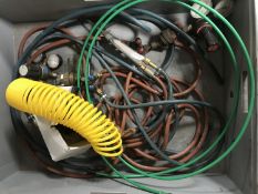 A plastic crate of compressor hoses