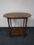 An Edwardian oak occasional table