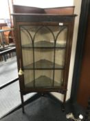 An Edwardian mahogany corner display cabinet