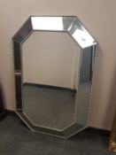 A contemporary hexagonal all glass mirror,