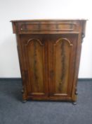 An antique continental mahogany double door cabinet