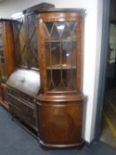 An inlaid mahogany corner display cabinet