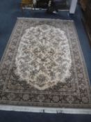 A fringed floral machine made carpet on brown ground