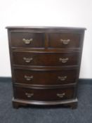 A 20th century walnut bowfront five drawer chest on bracket feet
