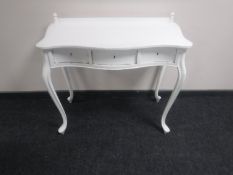 An oak serpentine fronted three drawer dressing table on cabriole legs