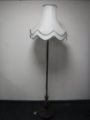 An antique rosewood standard lamp with shade