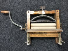 A vintage mangle bearing Anchor Brand Clothes Ringers advertisement