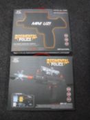 Two boxed Regimental Police electric mini uzi guns