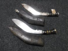 Two kukri knives in leather sheaths
