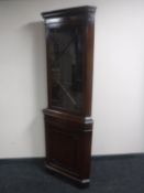 A mahogany corner display cabinet