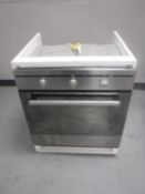 An Indesit electric wall cooker in cupboard