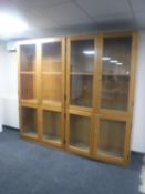 A pair of mid 20th century teak glazed door school bookcases