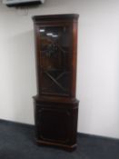 A mahogany corner display cabinet