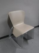 Seven plastic stacking chairs
