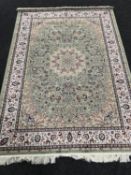 A Keshan rug on green ground,