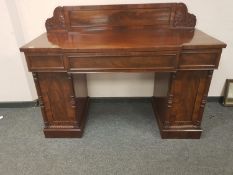 An early 19th century mahogany breakfronted pedestal sideboard,