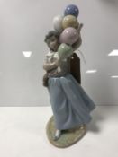 A Lladro figure of a girl carrying balloons aloft (1982) height 26cm