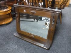 An Edwardian wall mirror with shelf and two coat hooks