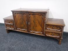 A continental mahogany double door cabinet fitted with four drawers