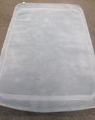 A hand knotted light blue rug,