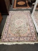 A Keshan rug on green ground,