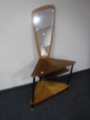 A mid twentieth century teak corner table together with a frameless mirror on teak board