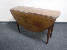 A Victorian mahogany drop leaf table on club feet