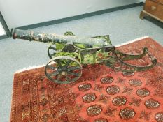A cast iron cannon on carriage, length 160 cm.