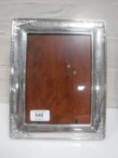 A silver photograph frame 19 cm x 24 cm