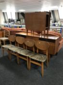A mid twentieth century teak six piece dining room suite comprising of sideboard,