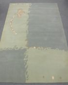 A hand-knotted rug in two-tone green,