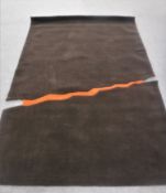 A hand-knotted rug on brown ground,