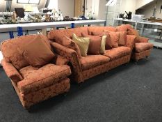 A three piece Duresta lounge suite upholstered in red and golden fabric