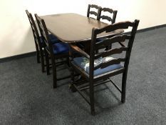 An Ercol refectory dining table and five oak ladder back chairs