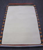 A hand knotted striped border cream rug,