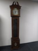 A Tempus Fugit longcase clock with pendulum and weights