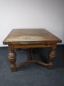 An early twentieth century oak pull out dining table on bulbous legs