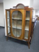 A late Victorian inlaid mahogany display cabinet with mirrored back