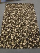 A hand-knotted rug of speckled design,