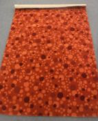 A hand-knotted rug on orange ground,