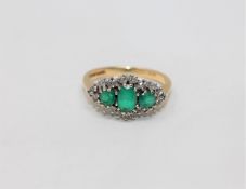 An 18ct gold diamond and emerald ring, size I CONDITION REPORT: 3.