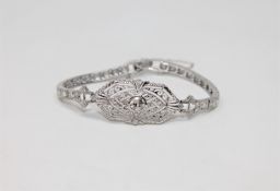 A platinum diamond bracelet featuring one round brilliant cut diamond 0.