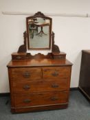 A Victorian walnut dressing chest with mirrored back, width 99 cm.